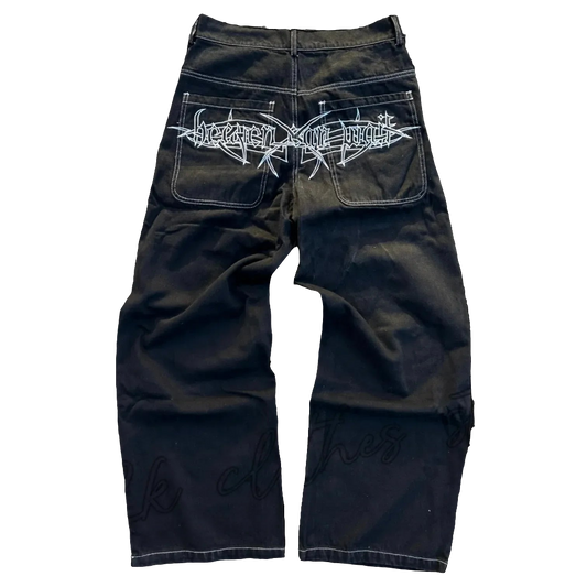 Black baggy jeans with graphic design featuring white detailed artwork on back pockets