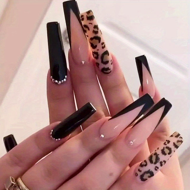 Long black, nude, and leopard print statement nails for alternative fashion with rhinestone accents