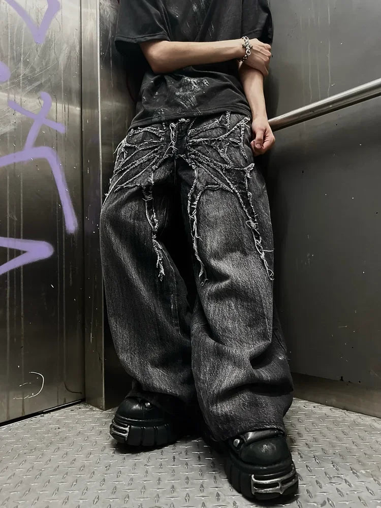 Person wearing black distressed jeans with chain details showcasing unique statement bottoms in an urban setting