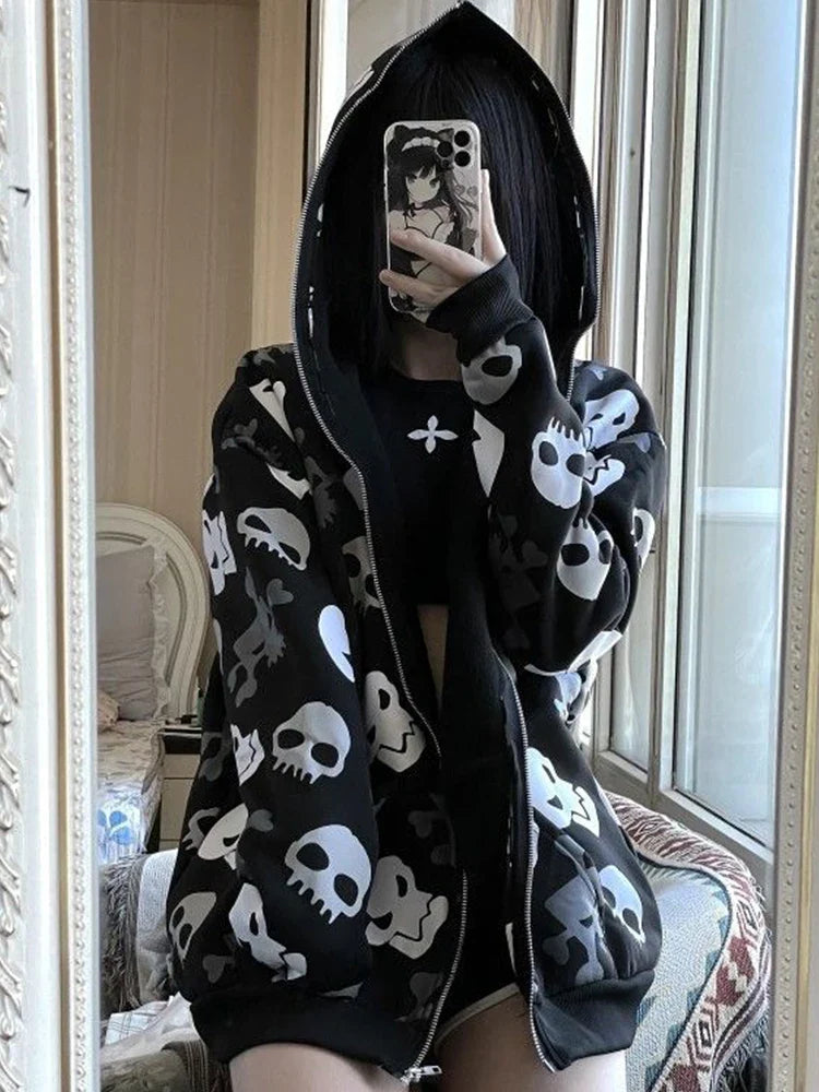 Person wearing unique goth hoodies for sale with skull patterns taking a mirror selfie indoors