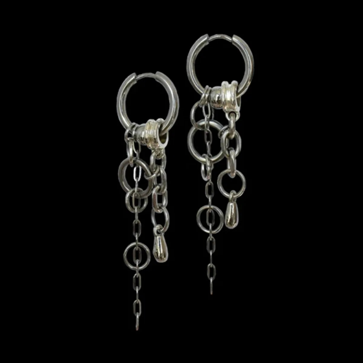 Silver hoop earrings with multiple chain links and dangling elements in edgy jewelry for emo style