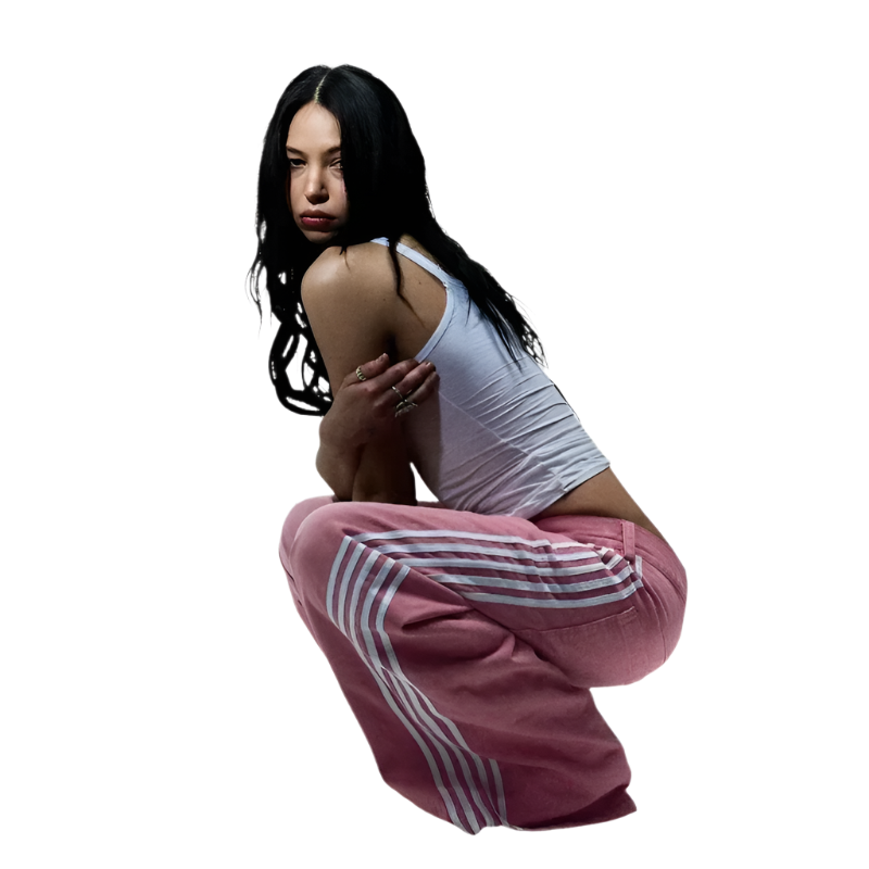 Woman wearing affordable baggy streetwear pants for men and women in pink with white stripes
