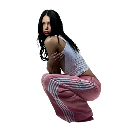 Woman wearing affordable baggy streetwear pants for men and women in pink with white stripes
