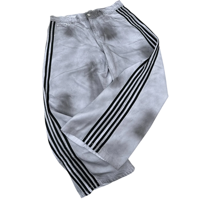Affordable baggy streetwear pants for men and women in light gray with black side stripes