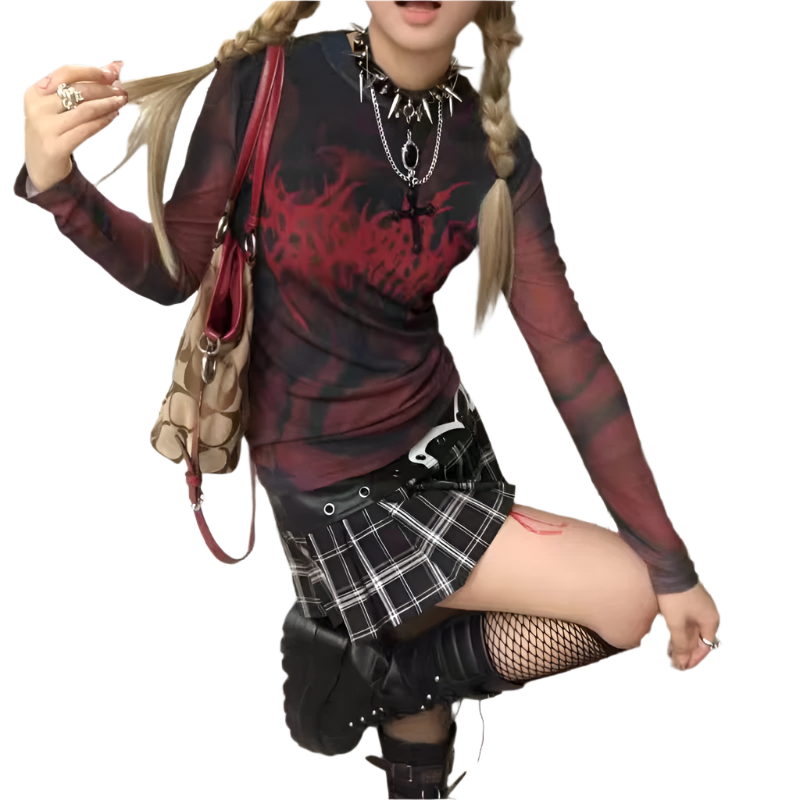 Alternative fashion red mesh shirt worn with black plaid skirt and fishnet stockings
