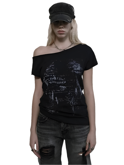 Weird0z black off shoulder cyber tee with futuristic graphic worn with distressed jeans and a black cap