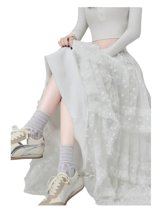 White maxi ruffled lacey skirt with floral patterns worn with sneakers and socks